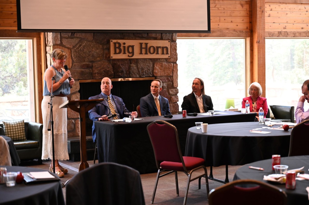 Tracey Johnson welcoming panelists (from left to right), CSWAC Board of Directors Chairman Karl Schneider, Monument Academy Principal David Kennington, CIVA Charter High School Executive Director Randy Zimmerman, and recent past President of Academy District 20 Board of Education Karin Reynolds.